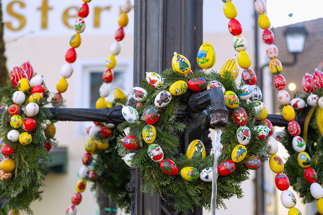 Easter fountain decorated with colorful Easter eggs and colored ribbons in Muggendorf in Franconian Switzerland, Bavaria, Germany