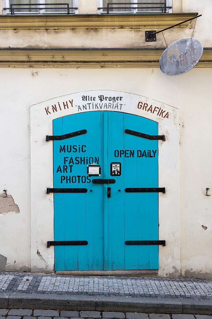 Light blue wooden door, entrance to an antique shop, Prague, Czech Republic