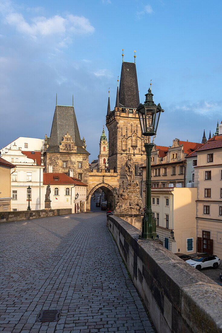Charles Bridge, Bridge Tower, behind it St. Nicholas Church, Prague, Czech Republic
