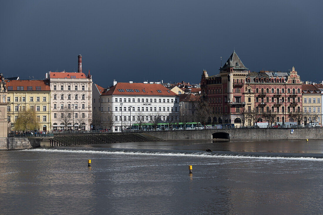 Dark rain clouds, flood protection system in the Vltava, parts of the old town, Prague, Czech Republic