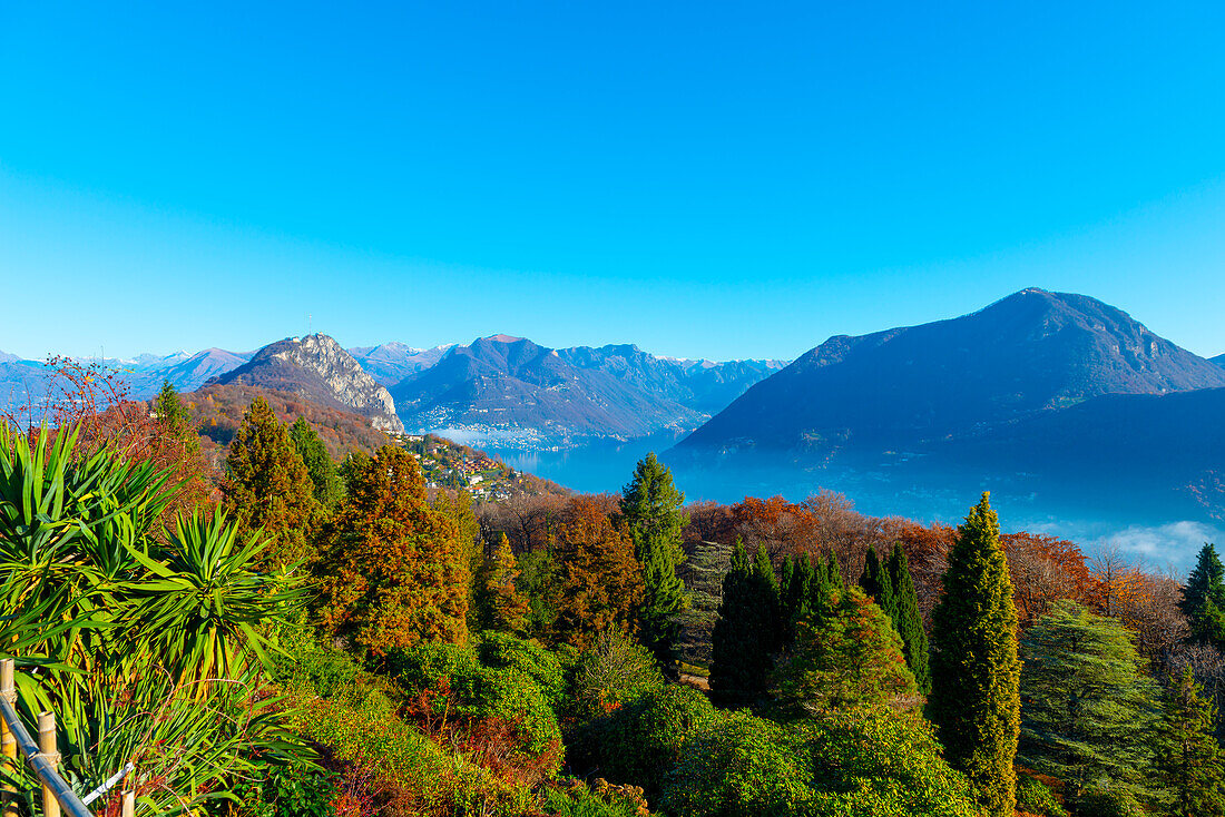 Mountain View over Lake Lugano with Sunlight and Clear Sky in Lugano, Ticino in Switzerland.