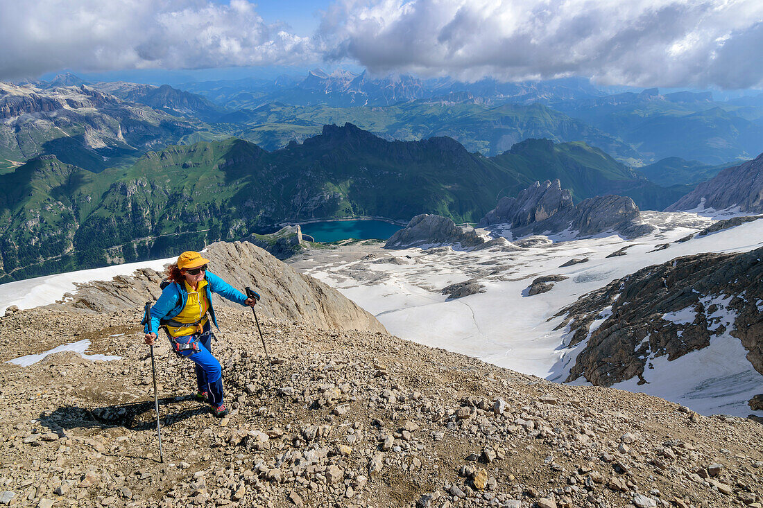 Woman mountaineering ascending to the peak of Marmolada, Marmolada, Dolomites, Dolomites UNESCO World Heritage Site, Trentino, Italy