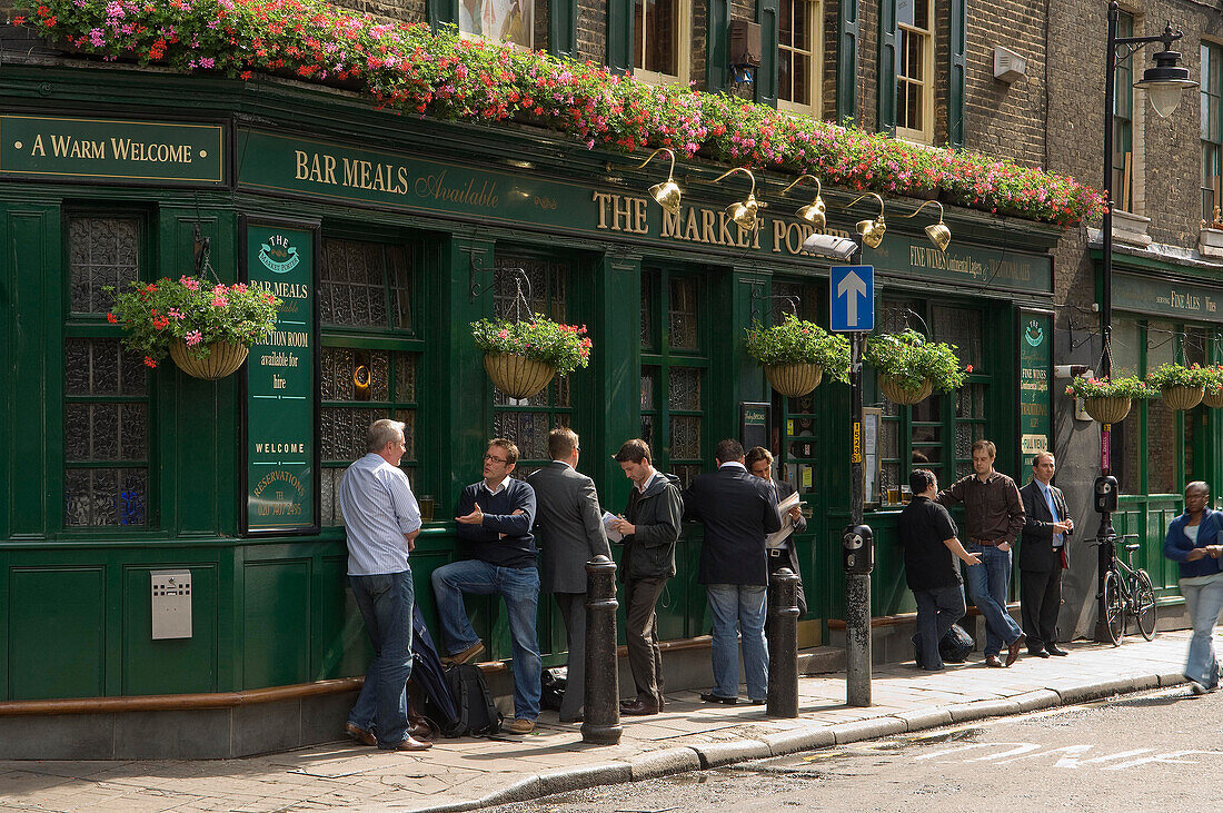 People standing outside a London pub, the Market Porter,London, England