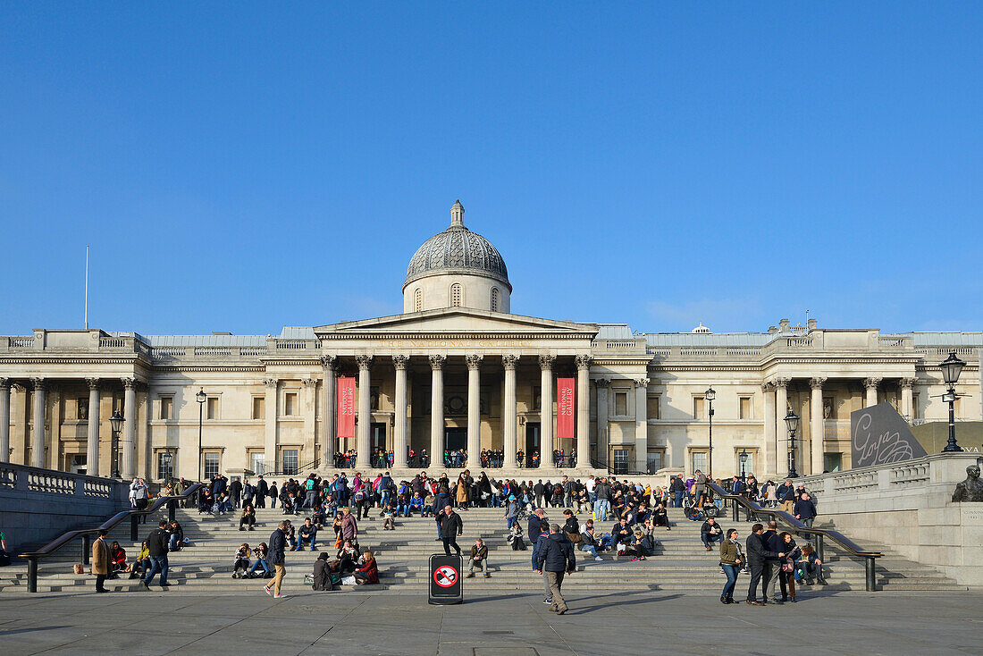 People on the steps, Trafalgar Square and The National Gallery, London, UK