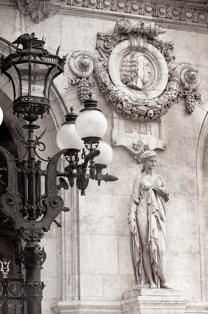 Bach head, lamp and female sculpture on the front of the Paris Opera, France