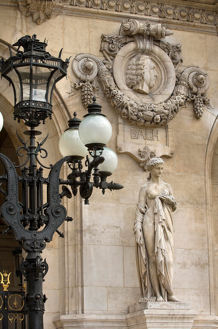 Bach head, lamp and female sculpture on the front of the Paris Opera, France