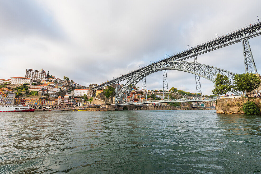 Dom Luís I truss arch bridge over Douro river and historic old town in Porto, Portugal