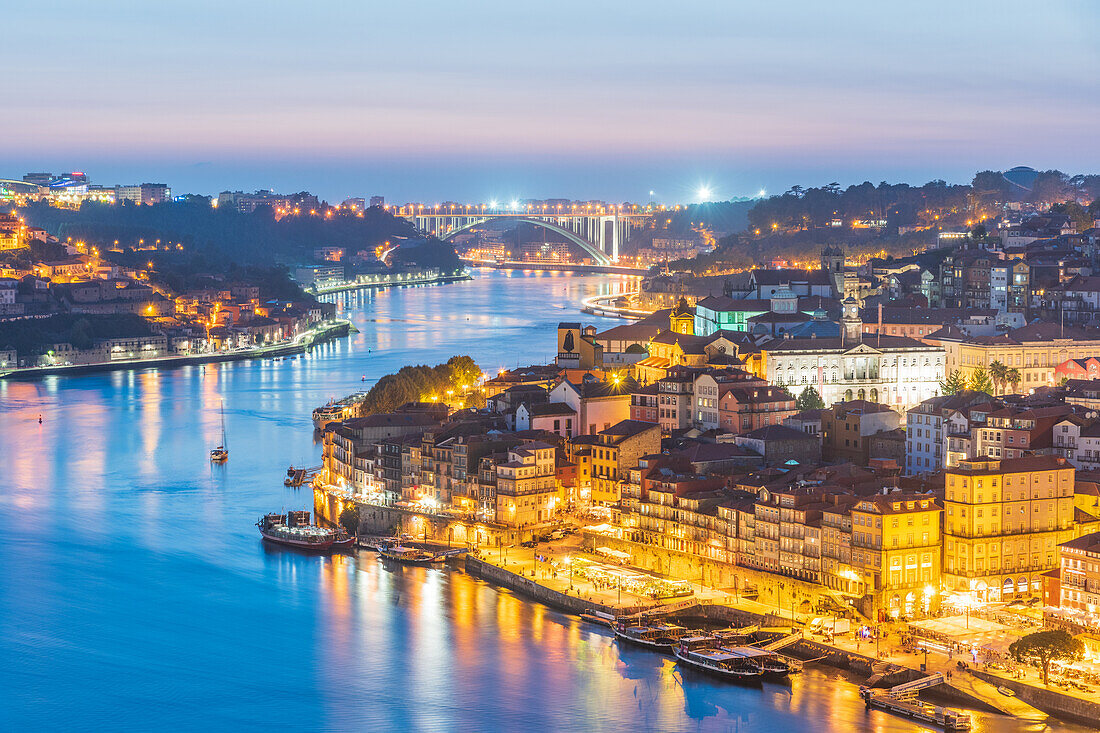 Night shot of the Cais de Ribeira waterfront promenade and the historic old town of Porto, Portugal