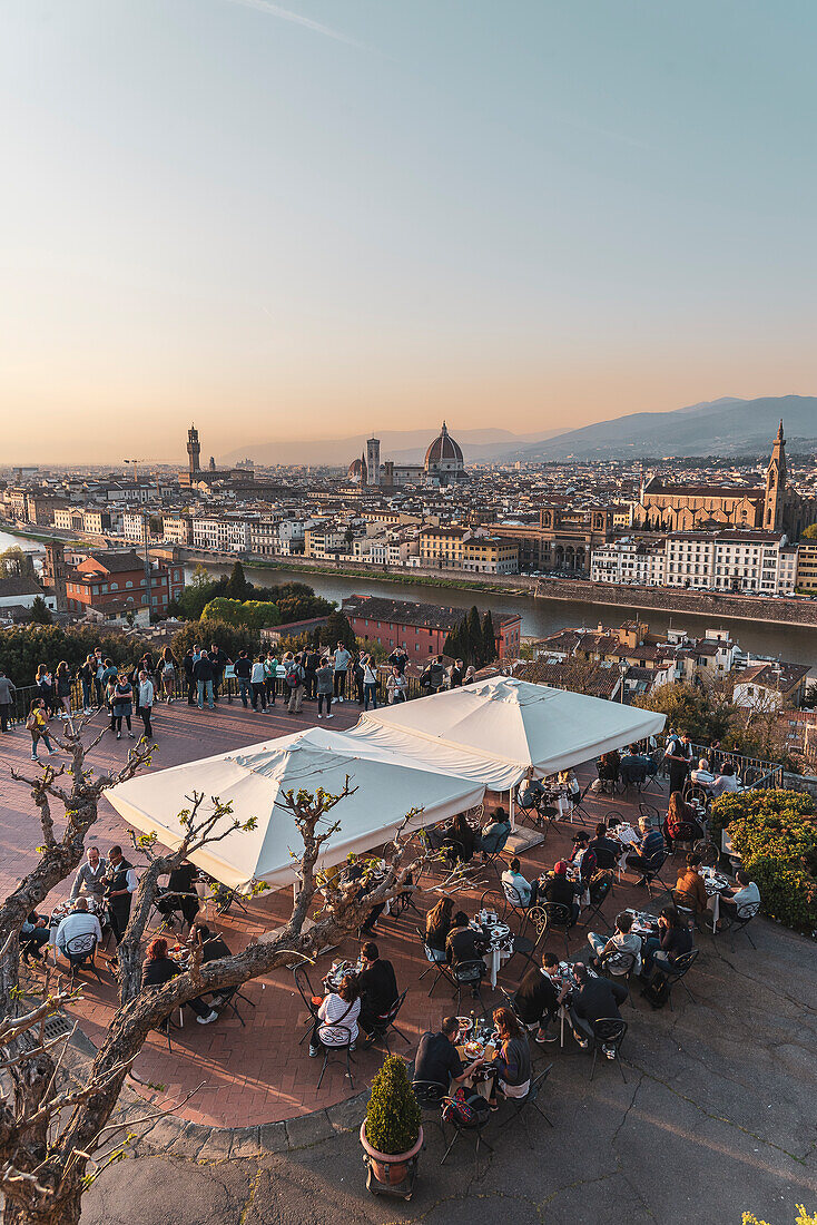 View over Florence at sunset, people enjoying the view from the cafe/restaurant, Florence city panorama from Piazzale Michelangelo, Tuscany, Italy, Europe