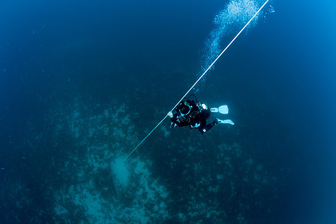 Divers at safety stop, Vis island, Mediterranean Sea, Croatia