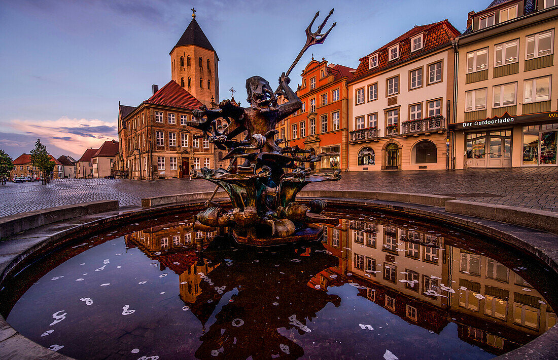 Market square with Neptune Fountain and Gaukirche in Paderborn in the evening light, North Rhine-Westphalia, Germany