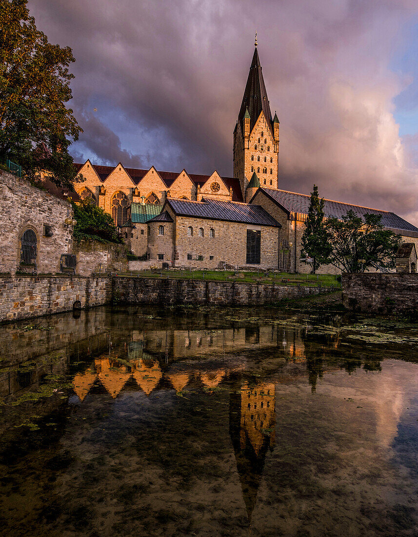 Cathedral and Imperial Palace in Paderborn, reflected in the Dielenpader spring basin, North Rhine-Westphalia, Germany