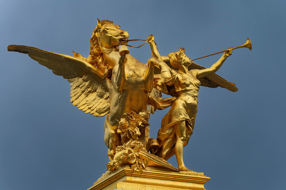 Column with the figure group 'Fama of War' on the bridge Pont Alexandre III. across the river Seine, Paris, France, Europe