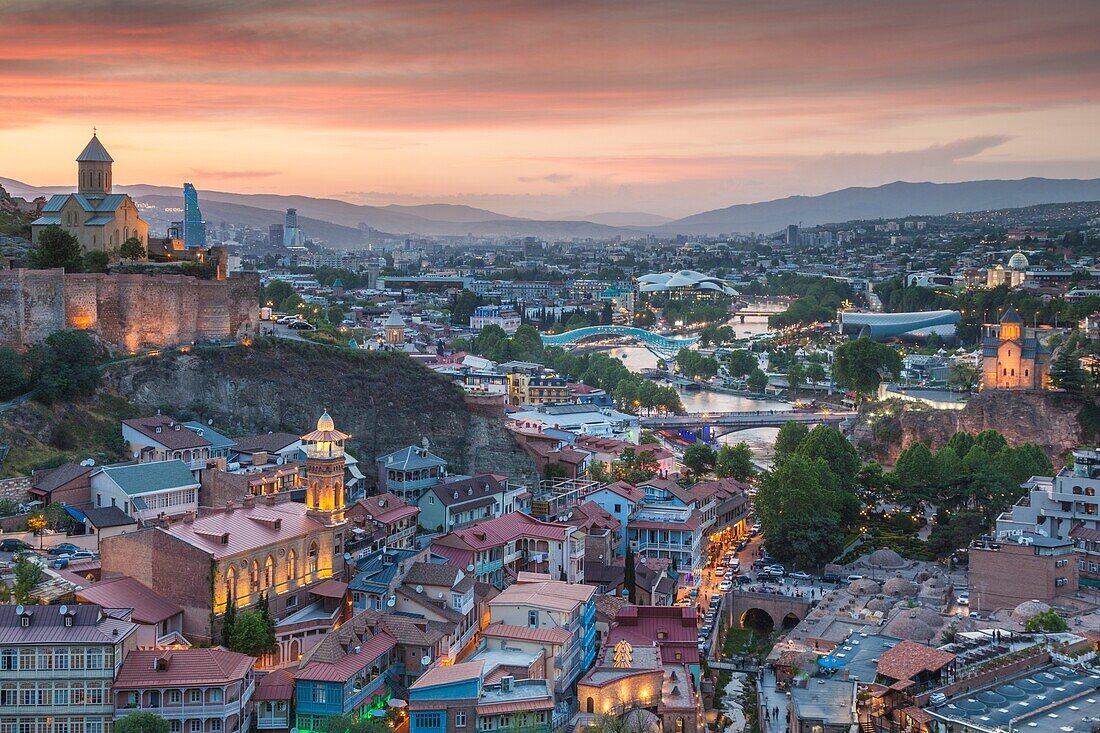 Georgia,Tbilisi,Old Town,Muslim Quarter and Narikala Fortress,high angle view,dusk.