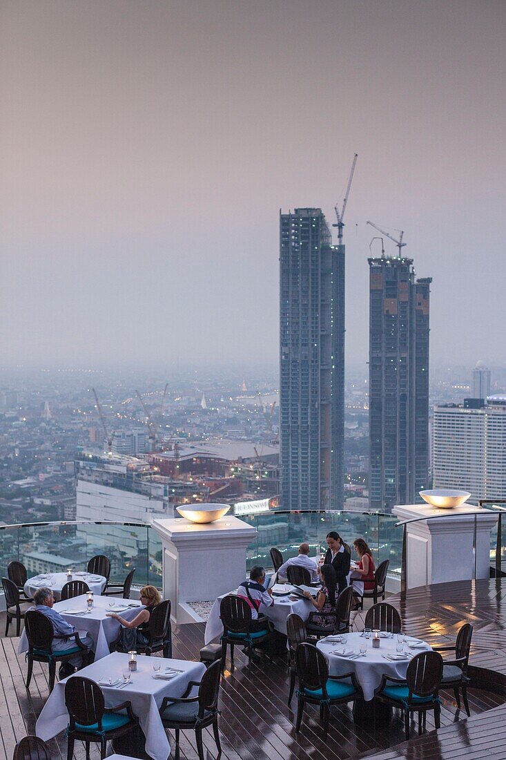 Thailand,Bangkok,Riverside Area,visitors to The Breeze Restaurant at the Lebua Hotel,dusk,NR.