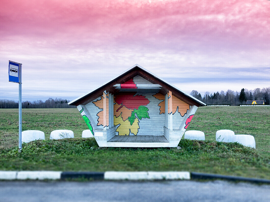 Roadside bus stop in Estonia, hay baled in white plastic sacks