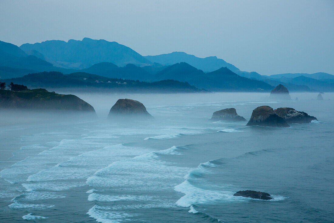 Indian Beach on Ecola State Parl with mist over waves breaking at dawn.