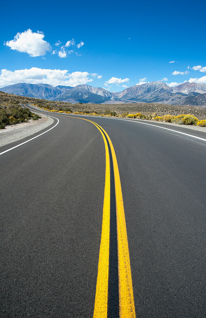 Empty road, Highway 120, curving around corner, near Mono Lakes, USA
