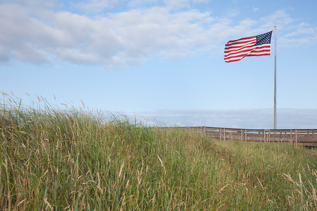 American flag flying in grassland, USA