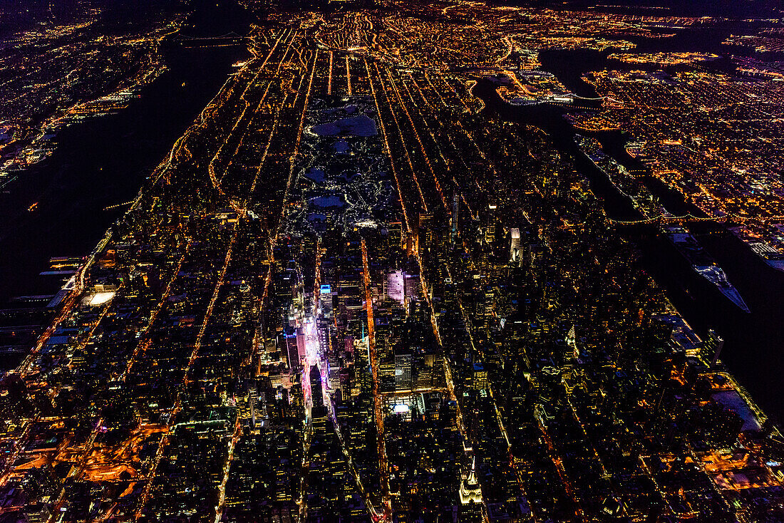The city of New York City, Manhattan, aerial view at night.