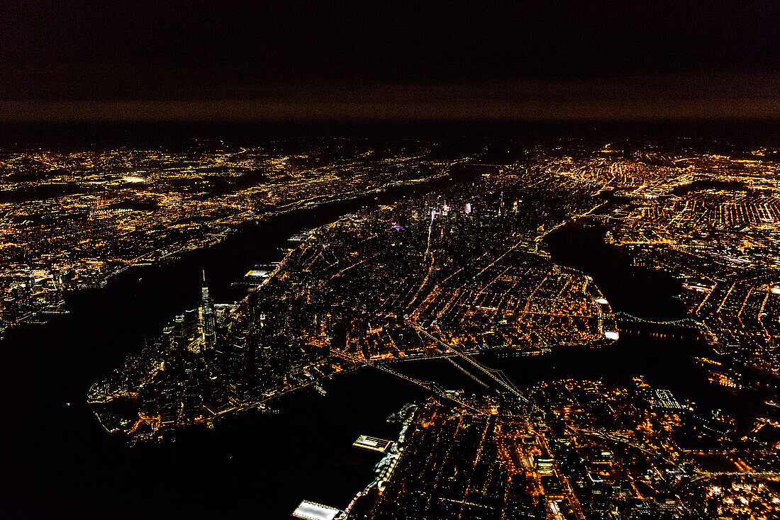 The city of New York City, Manhattan, seen from a high point at night.