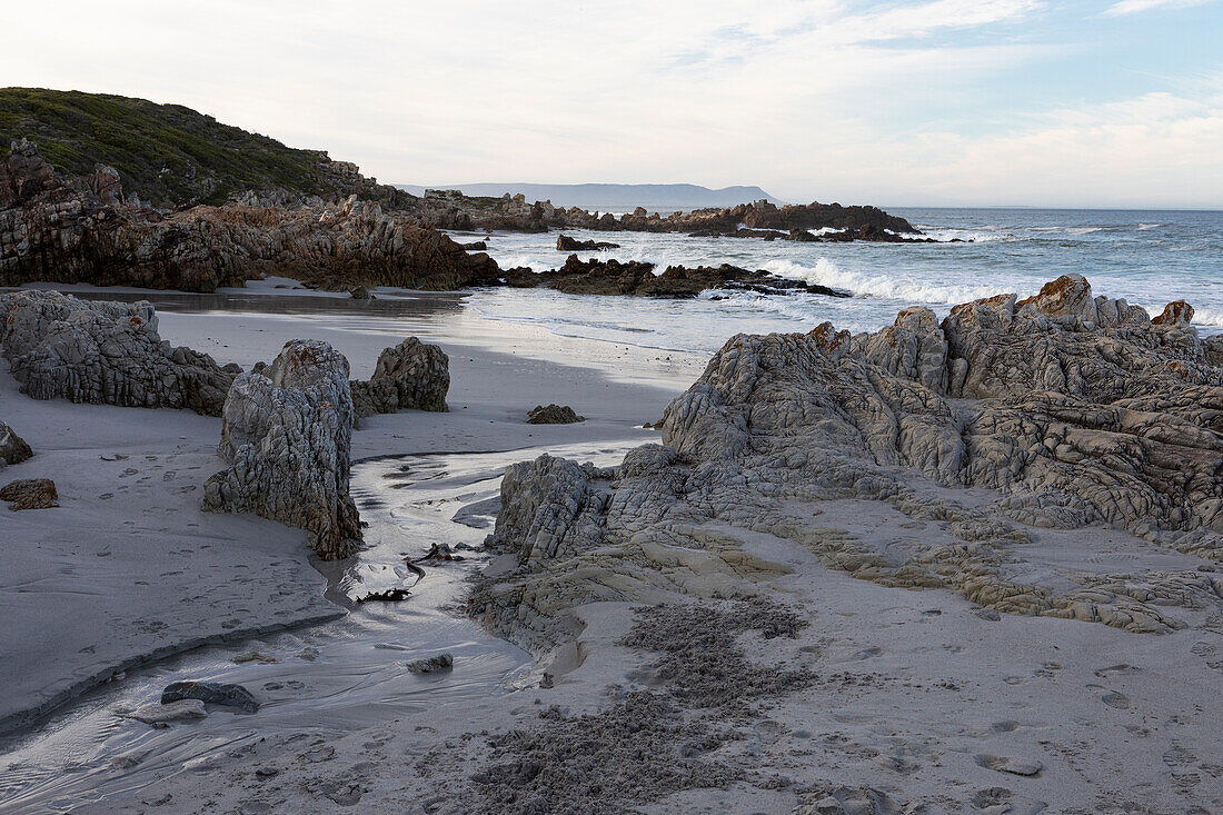 A deserted beach, jagged rocks and rockpools on the Atlantic coast, South Africa