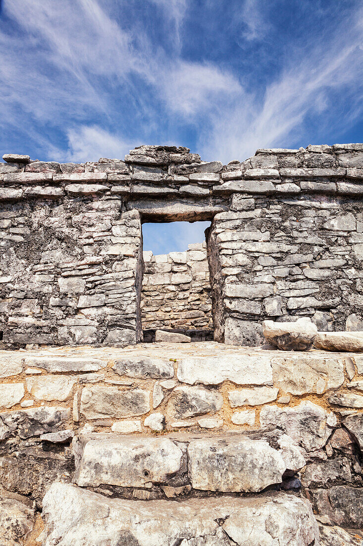 Stone steps and doorway in the archaeological site and Mayan ruins of Tulum, Mexico