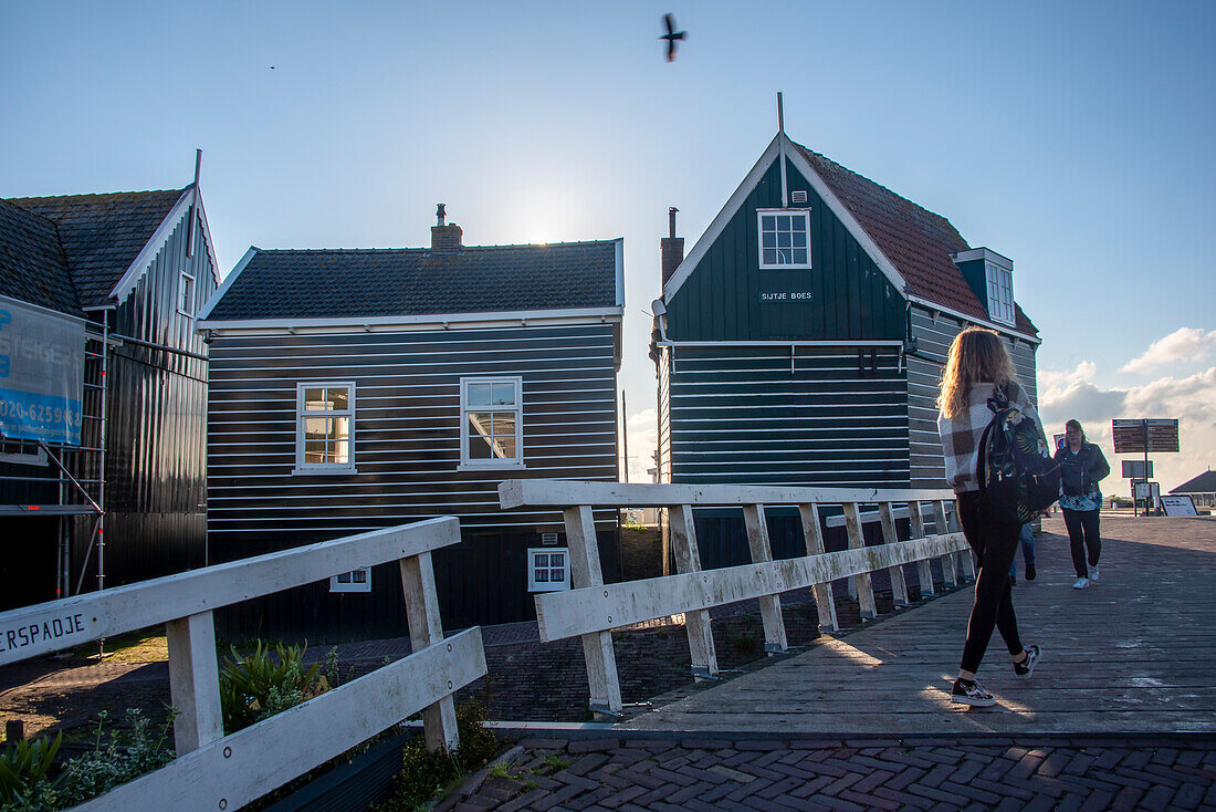 Characteristic wooden houses, bridge, people walking, Marken peninsula, near Amsterdam, North Holland, Netherlands