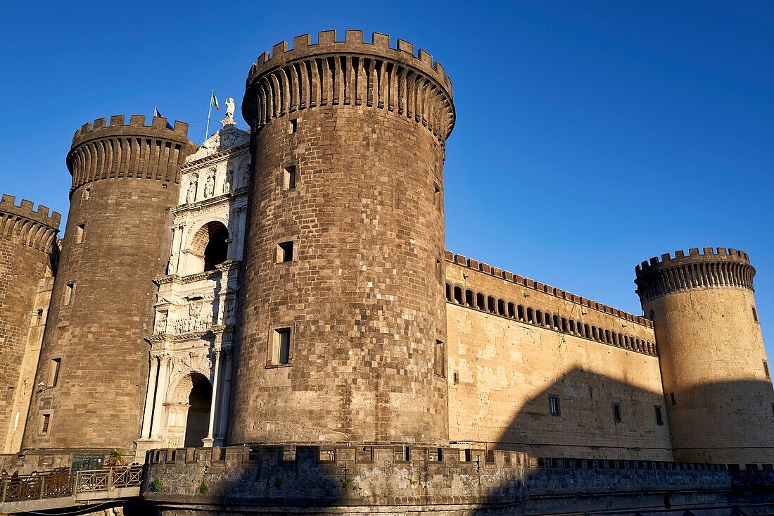 Naples,Campania,Italy. Castel NuovoA (New Castle),often calledA Maschio Angioino,is aA medievalA castle located in front of Piazza Municipio and the city hall (Palazzo San Giacomo) in centralA Naples,A Campania,A Italy. Its scenic location and imposing size makes the castle,first erected in 1279,one of the main architectural landmarks of the city. It was a royal seat for kings of Naples,Aragon and Spain until 1815.
