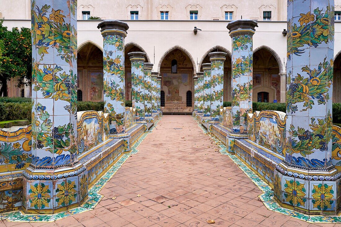 Naples Campania Italy. Santa Chiara Basilica Church. The cloister of theA Clarisses,transformed in 1742 by Domenico Antonio Vaccaro with the unique addition ofA majolicaA tiles inA RococoA style. A The brash color floral decoration makes this cloister,with octagonal columns in pergola-like structure,likely unique and would seem to clash with the introspective world of cloistered nuns. The cloister arcades are also decorated by frescoes.