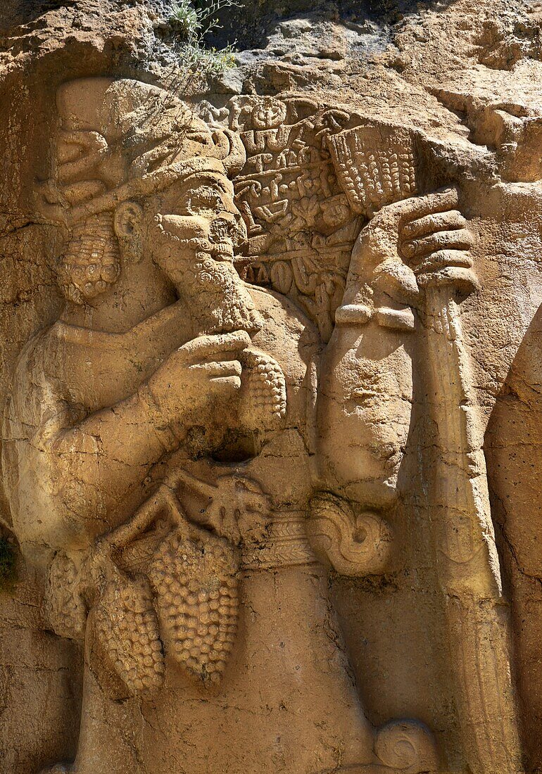 Ivriz Hittite rock relief sculpture monument dedicated to King Warpalawas in which he talks to Tarhundas the God of Thunder. The king is positioned in the opposite of god,smaller and in a praying position. Warpalawas is saying 1 am Warpalawas the king of Tuwana,the ruler and a hero. I planted these grapes while I was a young prince in the palace. Let the god Tarhundas give plenitude and fertility. a.Ivriz,Turkey.