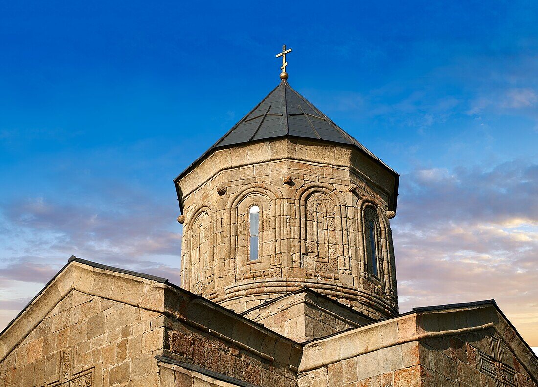 Gergeti Holy Trinity (Tsminda Sameba) Georgian Orthodox and Apostolic Church cupola close up,14th century,Gergeti,Khevi province,Georgia (country). At Sunset.
