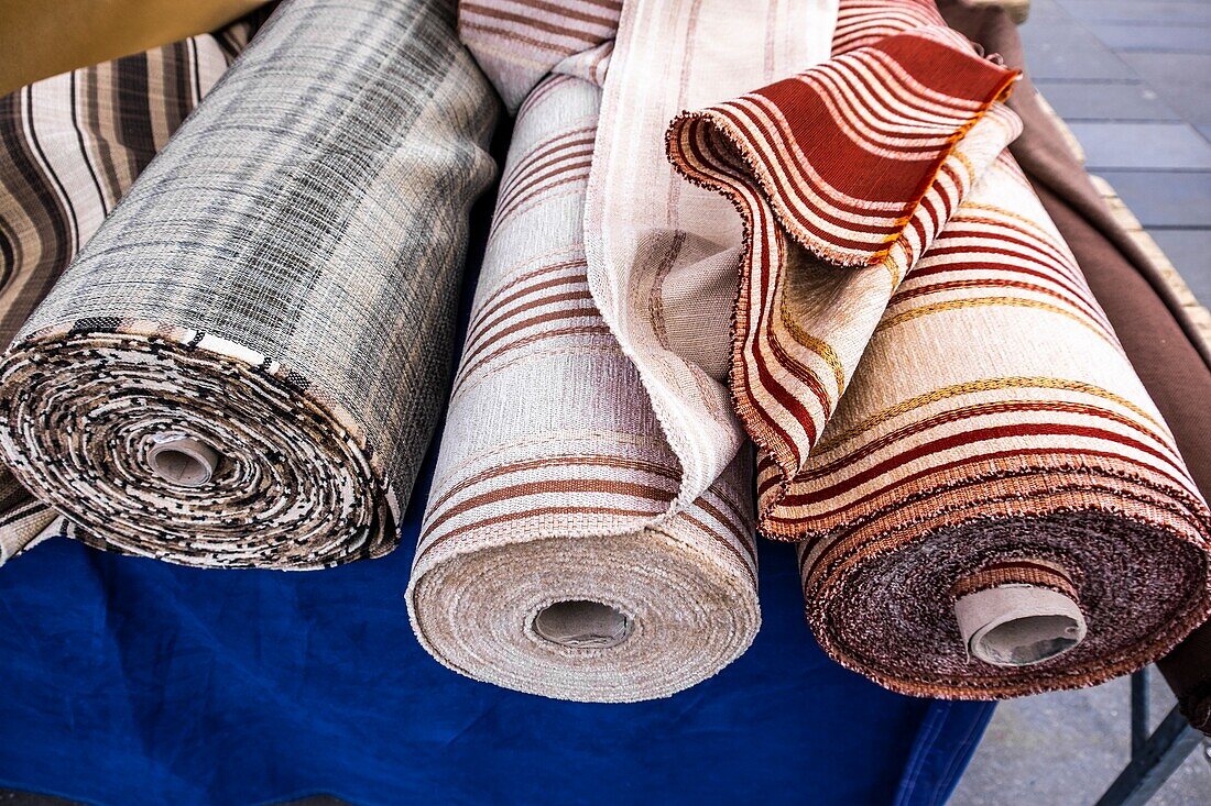 Composed roll shaped stacked fabrics at a Dutch market in Eindhoven,The Netherlands,Europe.