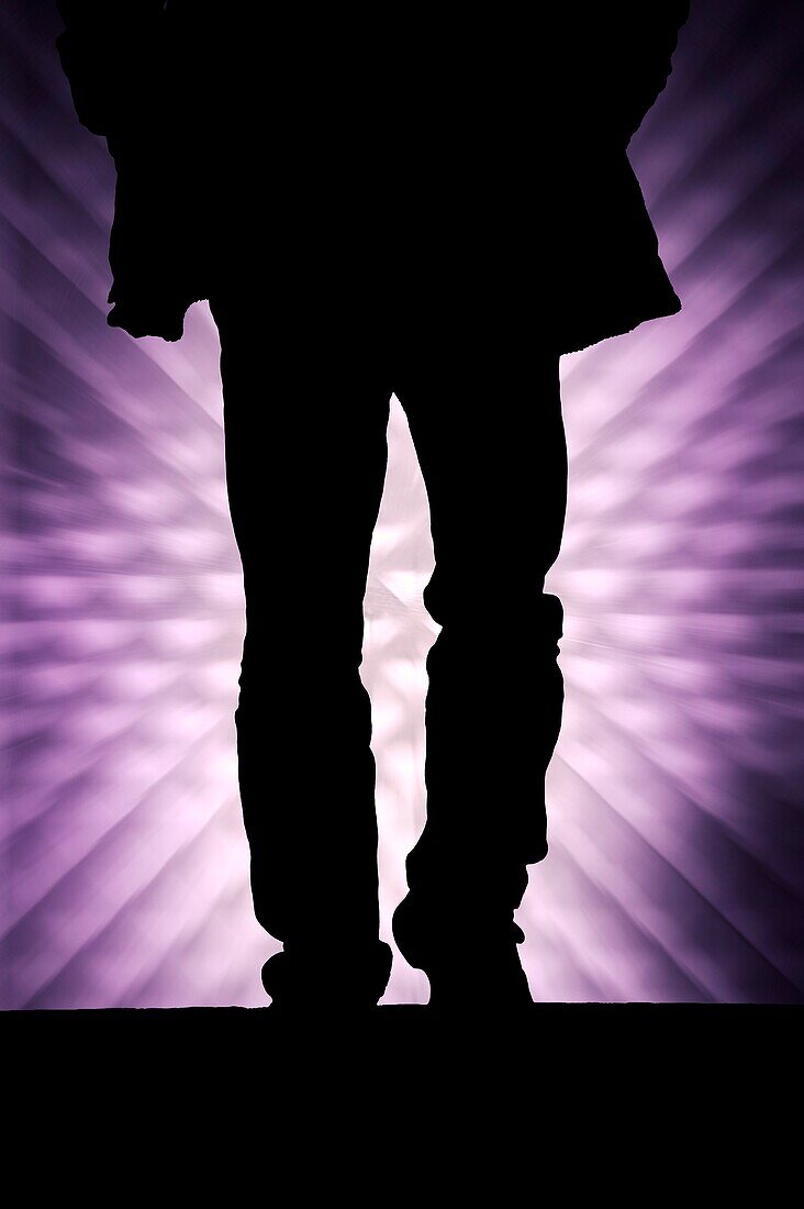 Silhouette of a walking man against a graphic background.