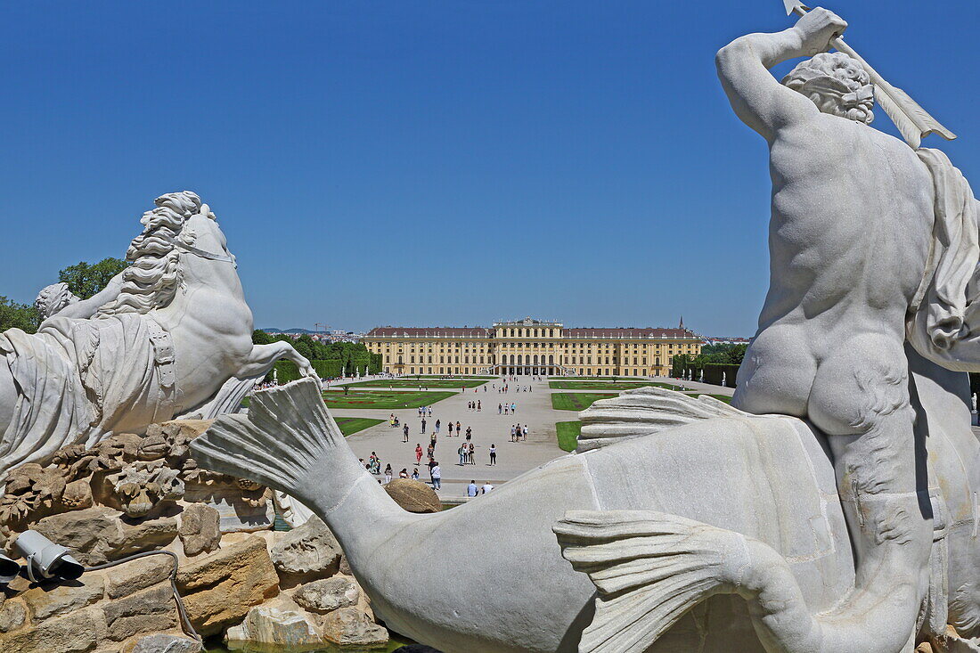 Figures of the Neptune Fountain with Schönbrunn Palace, Vienna, Austria