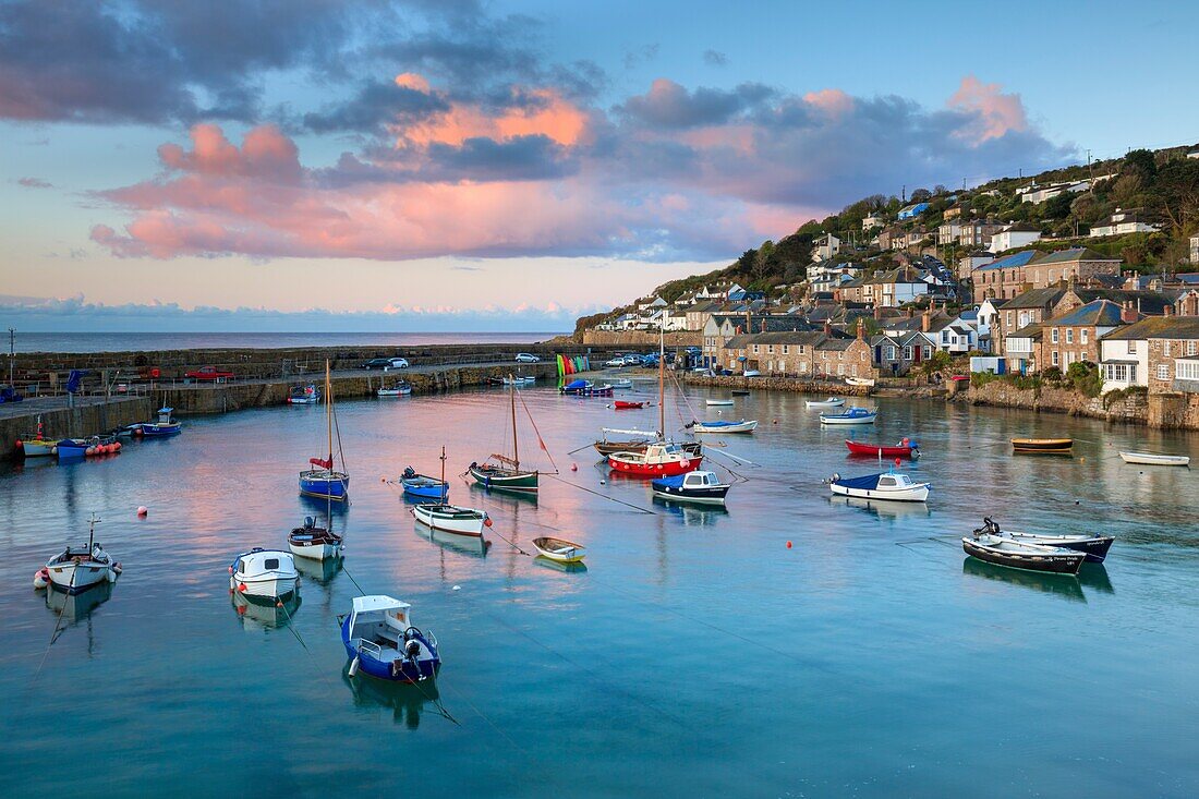 The picturesque harbour at Mousehole on the western side of Mount's Bay in Cornwall. The image was captured at sunrise on a still morning in late April.