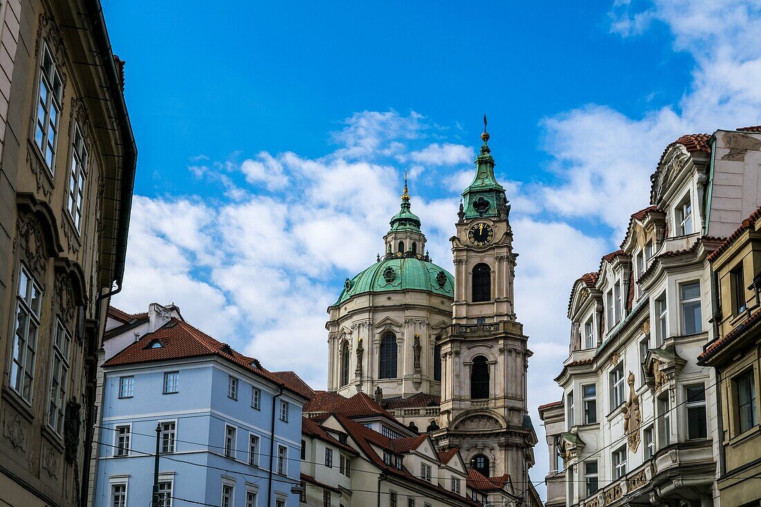 Czech buildings in Mala Strana street with St. Nicholas Church in the background,Prague,Cezch Republic