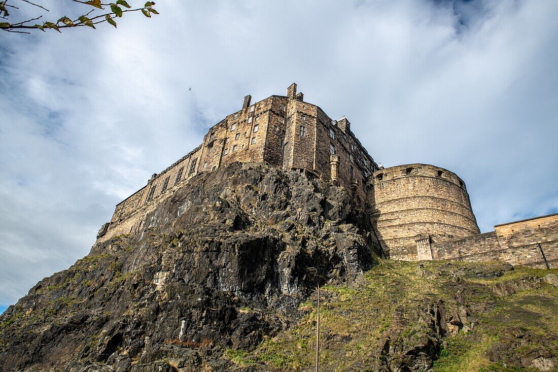 Looking up at the historic fortress of Edinburgh Castle sitting on the edge of a rocky cliff,Edinburgh,Scotland.