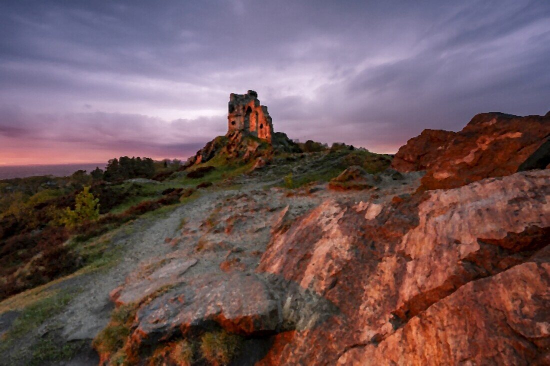 The Folly at Mow Cop beleuchtet von einem atemberaubenden Sonnenuntergang, Mow Cop, Cheshire, England, Vereinigtes Königreich, Europa