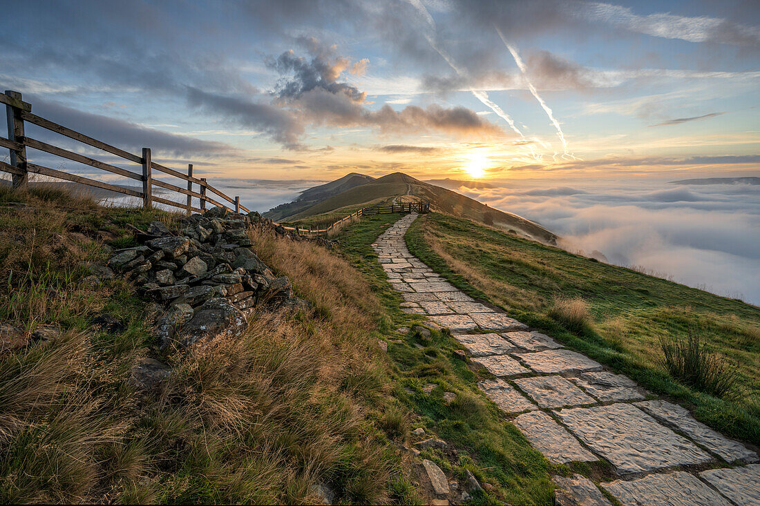 Flagged path leading to Losehill and Great Ridge with rolling mist in Edale Valley, Derbyshire, England, United Kingdom, Europe