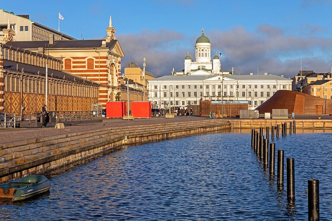 the historic 19th century vanha kauppahalli covered market on the port with the facade of the city hall and the green dome of the bell tower of the lutheran cathedral of helsinki, finland, europe