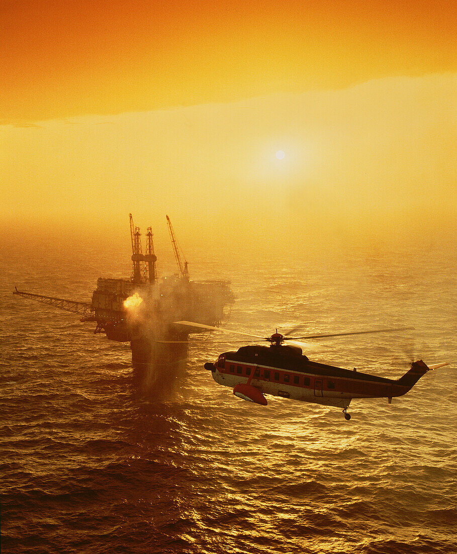 UK, Scotland, Helicopter flying towards offshore platform