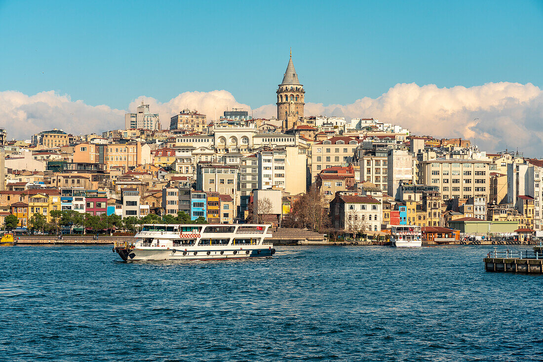 Turkey, Istanbul, Tourboat in Golden Horn waterway and Karakoy neighborhood