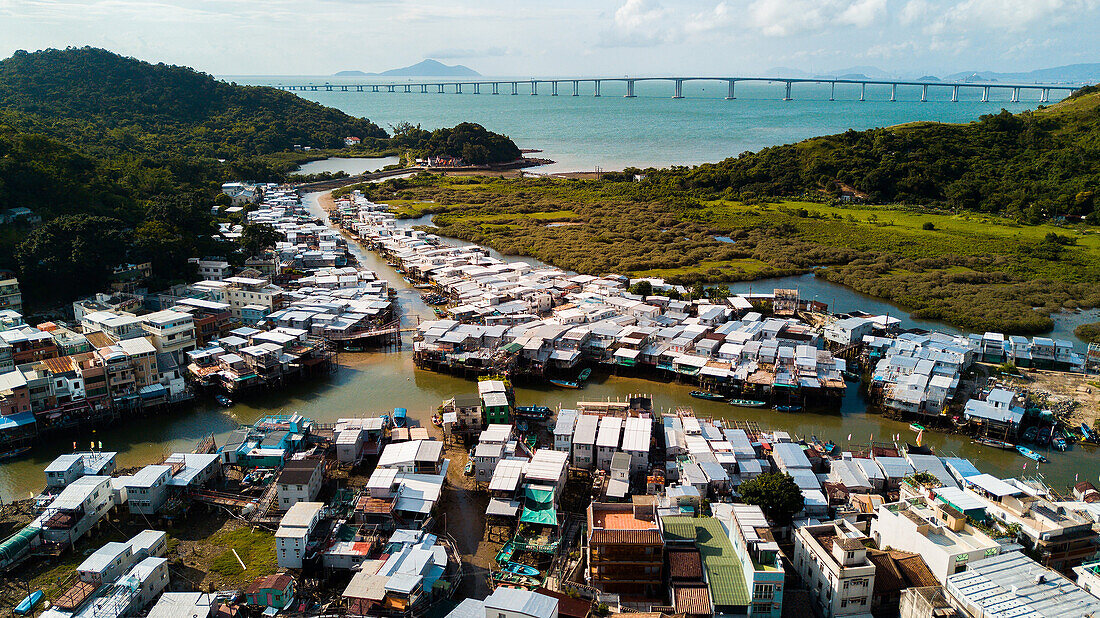 View of residential houses with boats moored in harbour, Hong Kong