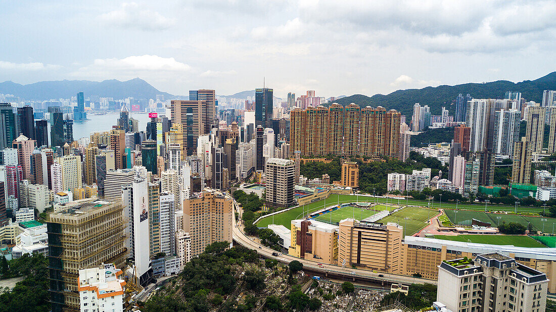 View of modern cityscape with stadium near Victoria Harbour in Hong Kong