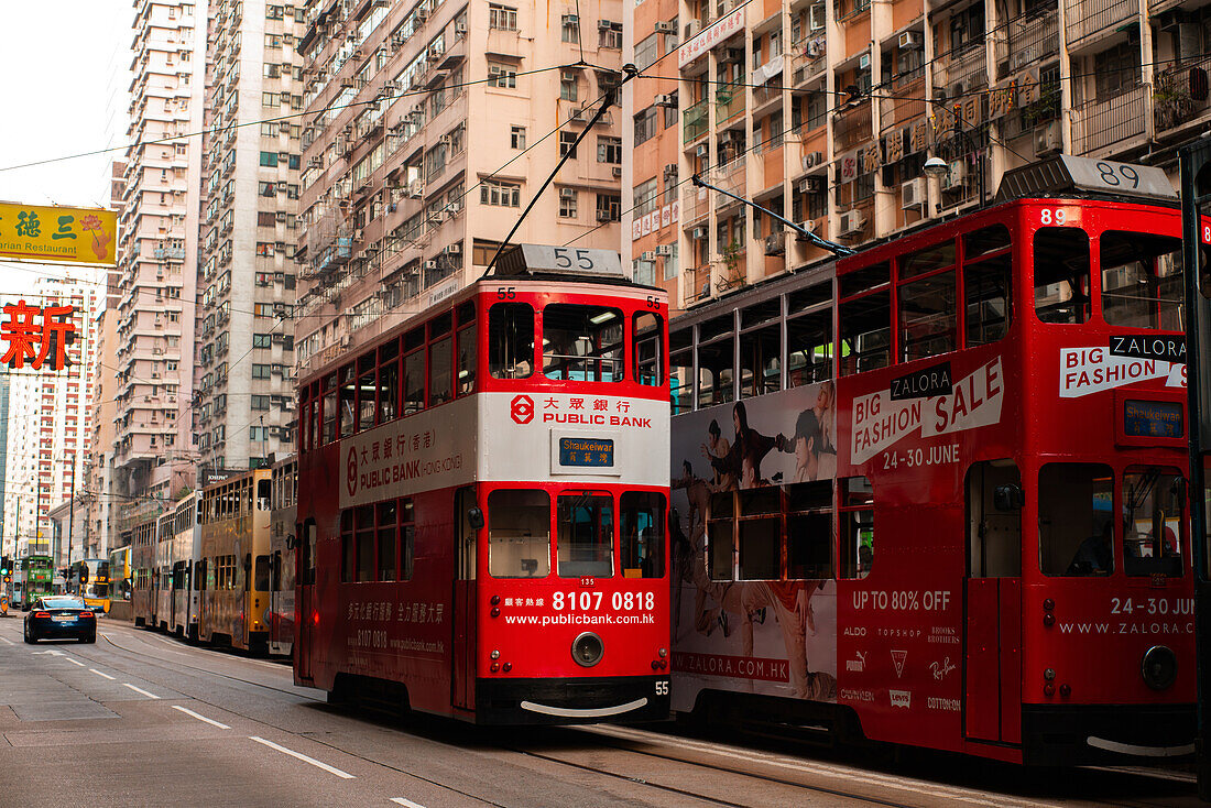 Double decker trams moving on city street, Hong Kong
