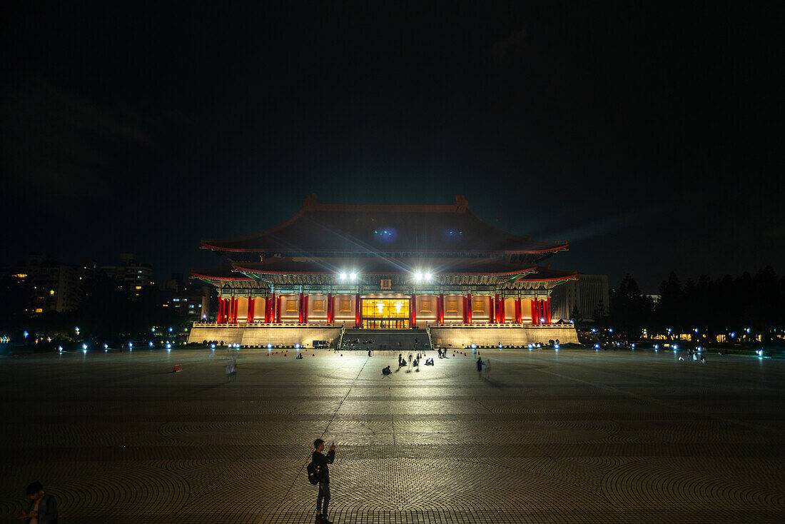 View of illuminated temple with courtyard in Taipei
