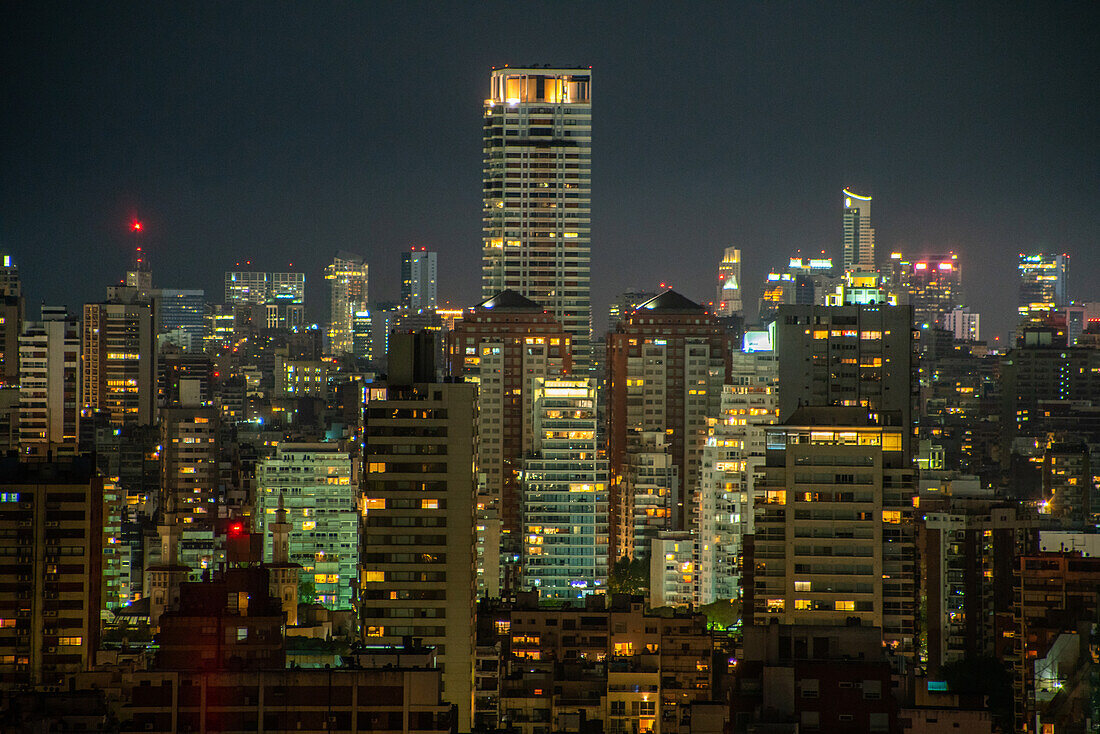 Aerial view of cityscape with residential buildings and office buildings at night