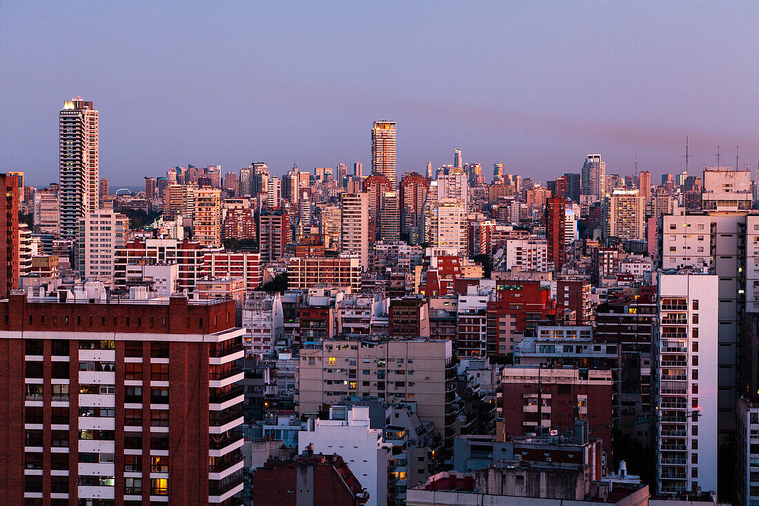 View of cityscape with residential buildings and office buildings at dusk