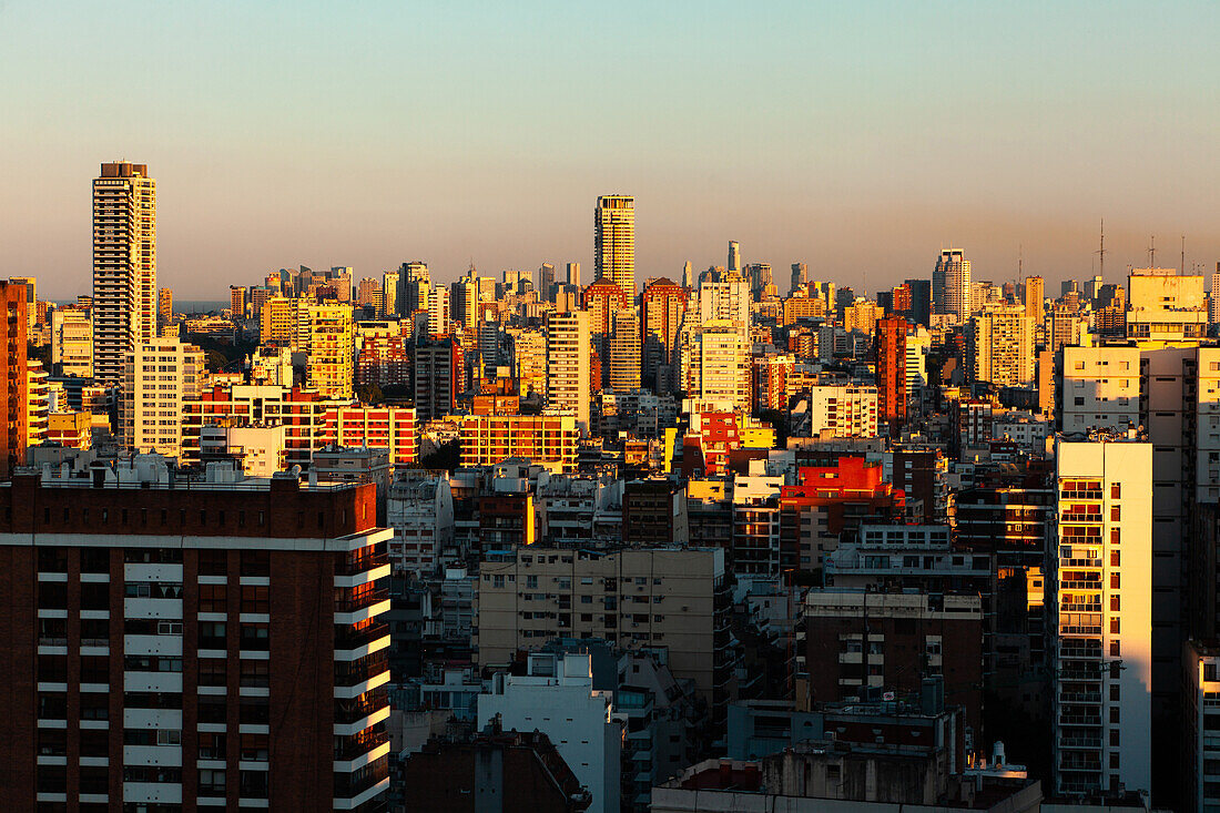View of cityscape with residential buildings and office buildings at sunrise